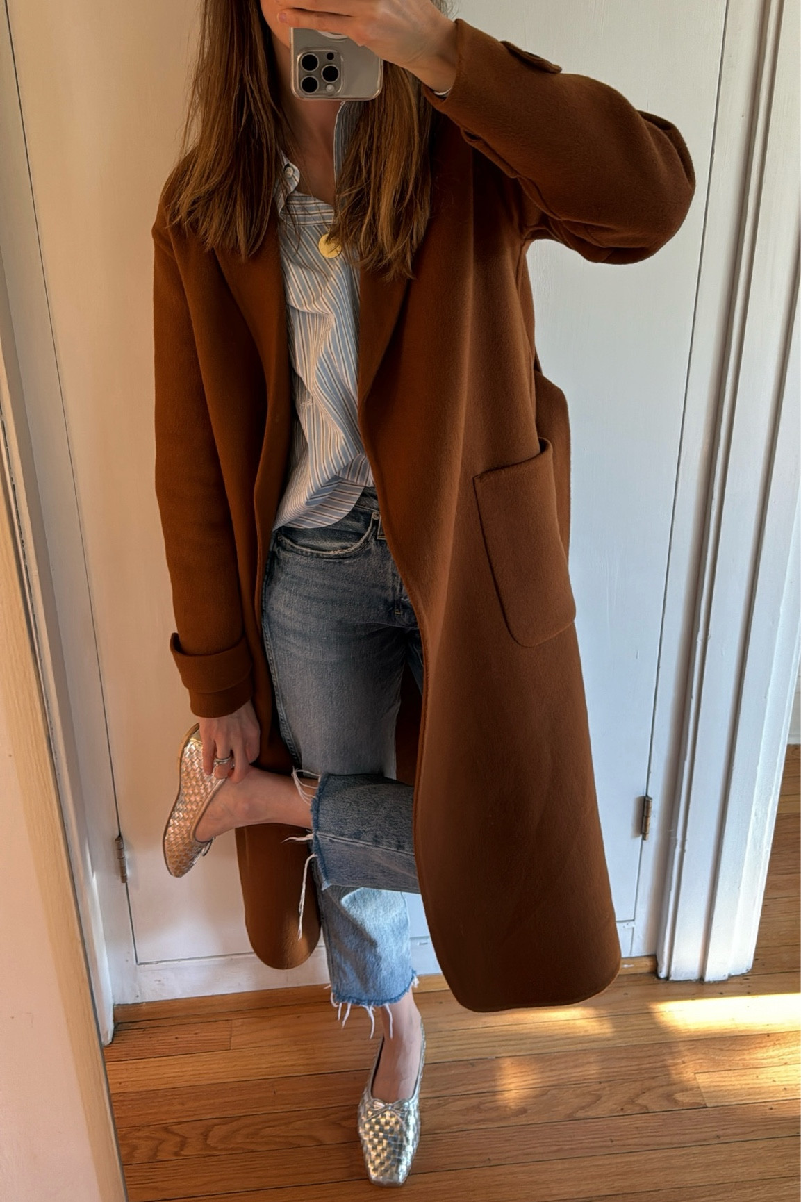 Classics that are always in style - a blue striped button down, camel over coat, perfect fitting denim, and ballet flats.

#LTKstyletip #LTKover40