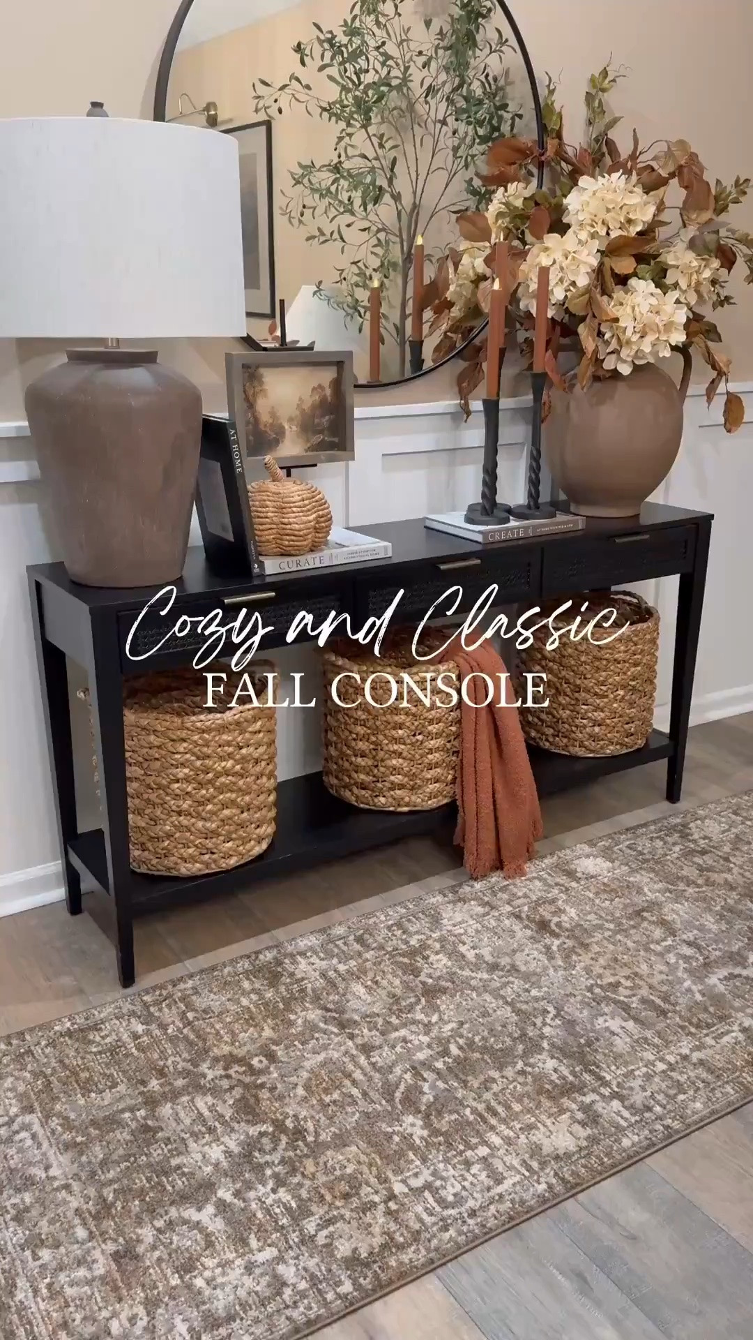 🍂✨Cozy & Classic Fall Console. 

Follow @farmtotablecreations on Instagram for more cozy home inspiration.

For reference:
•7x9 artwork in Briarsmoke stain. Use code FARMTOTABLE for 15% off. 
•Oversized Vase Florals:
3 Magnolia Stems
4 Cream Hydrangeas 
2 Grape Ivy Leaf Branches

This console is all dressed up for fall with layers of warmth and texture 🤎 From the oversized vase filled with rich autumn stems to the woven baskets, textured lamp, and cozy throw, every detail adds depth and coziness to the space. I love using stacked books and candleholders to bring height and balance, making it feel collected yet functional.

These pieces are timeless staples that you can easily mix and match for any season, and most are from my favorite retailers — simple swaps like stems and throws make it easy to transition your look from season to season.

#fallconsole #entrywaytable #fallstyling #fallhomedecor #falltabledecor #consoledecor #fallvibes #baskets #fallflorals #tablelamp #candlesticks #throwblanket #autumnvibes #homedecorideas

#LTKSaleAlert #LTKSeasonal #LTKHome