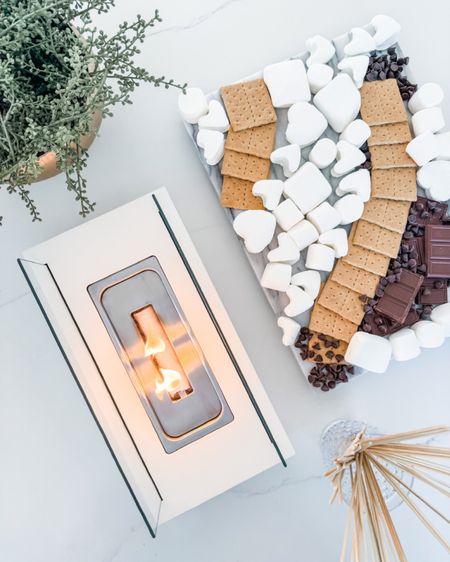 This little indoor fire pit is such a fun date night idea 👏🏼 make your own heart shaped smores! 

Date night, fire pit, indoor fire pit, solo stove, smores, Valentine’s Day, date idea, chocolate, hersheys, graham crackers, marshmallows, cookie cutter, marble serving tray, gold bowl, hobnail glasses, Modern home decor, traditional home decor, budget friendly home decor, Interior design, look for less, designer inspired, Amazon, Amazon home, Amazon must haves, Amazon finds, amazon favorites, Amazon home decor #amazon #amazonhome



#LTKparties #LTKwedding #LTKhome