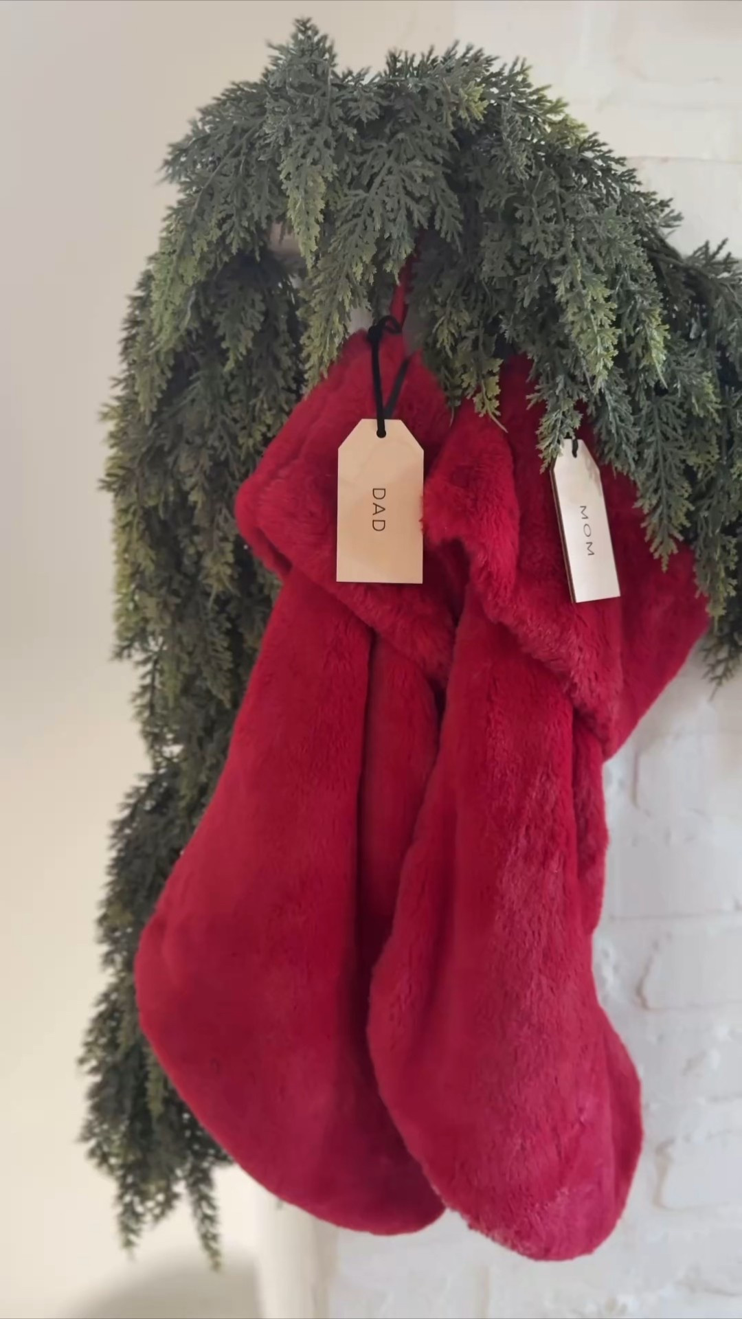 Christmas mantel ❤️ I got the garland from hobby lobby and added battery pack Christmas lights, red faux fur stockings are from Tj Maxx and the Martha Stewart brand and ordered the personalized name stocking tags from Etsy ! 