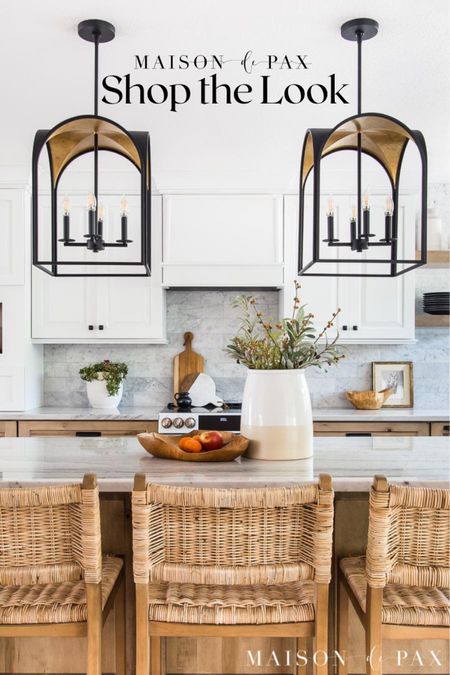 A serene modern rustic kitchen welcomes you with beautiful light fixtures, marble, and decorative accents. Barstools, Hunter, florals  

#LTKfamily #LTKhome