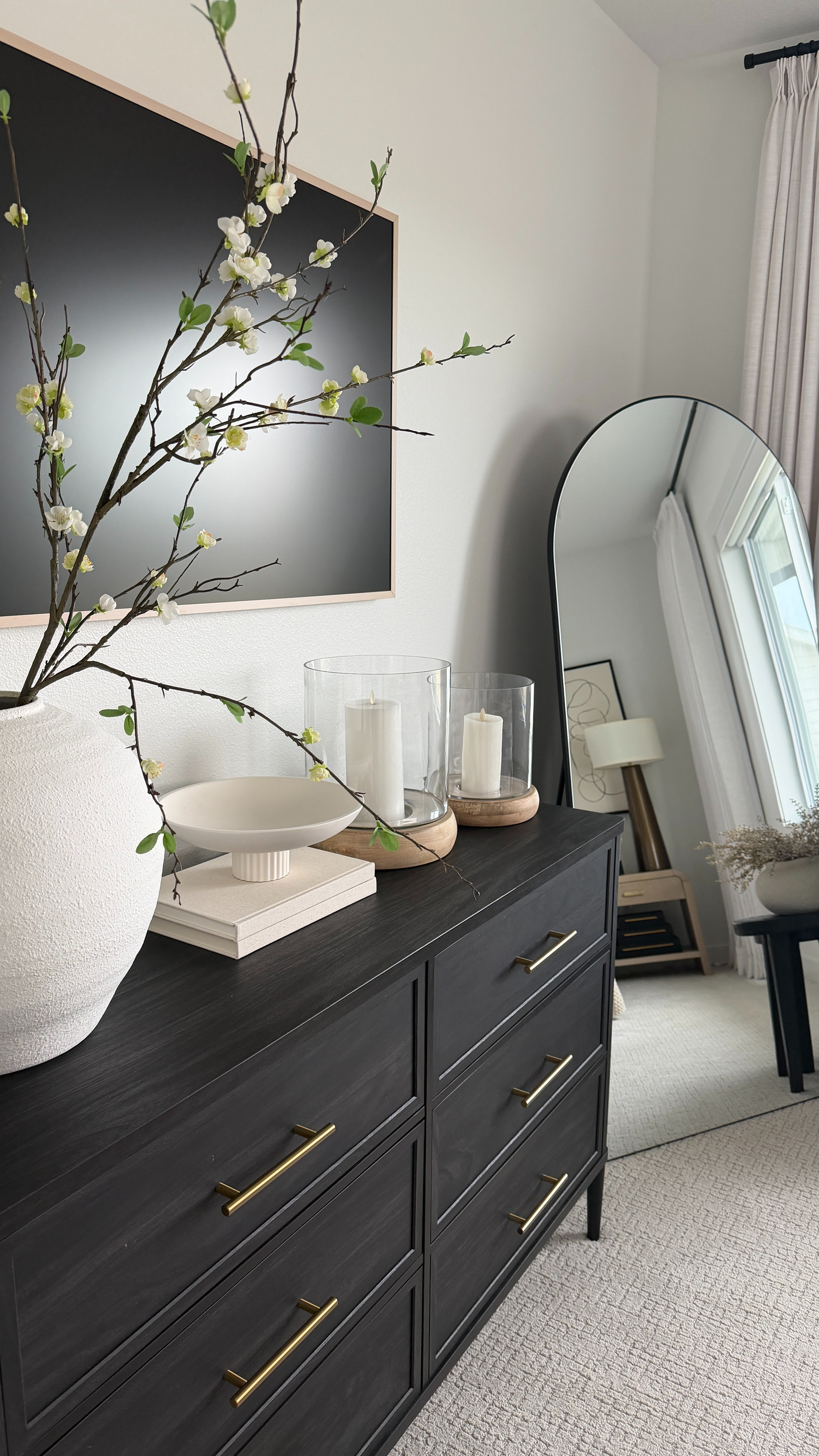 My bedroom dresser styling with neutral pieces completely transforms the space and gives it that wow moment 🤍 I layered a vase with stems and hurricane candles to add height, warmth, and that soft glow that makes the whole room feel finished. 

 

#LTKHome