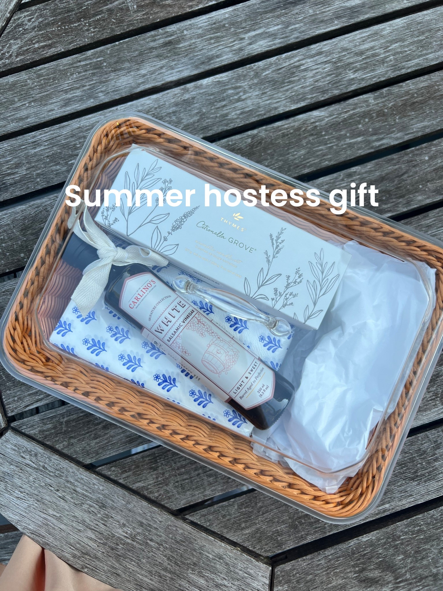 A summer hostess gift idea 

Woven serving basket
Citronella candles
Pretty napkins
Local gourmet item 
Outdoor plates 