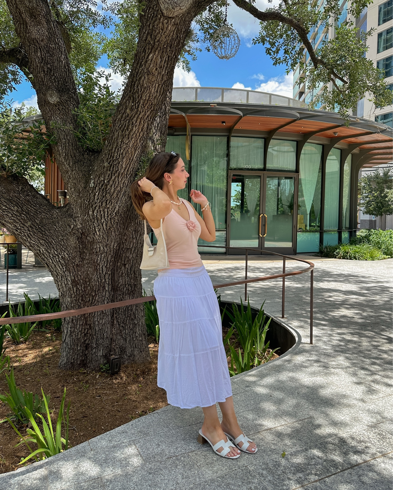 weekends in the city outfit 🤍🌸🪐

• sleeveless rosette top: aritizia (wearing size small. fits tts & is stretchy) 
• white tiered maxi skirt: amazon (wearing small. this skirt is cheaper quality than I expected so tagging similar ones too 🤍) 
• sandals: justfab 
• buckle shoulder bag: old urban outfitters

[cottagecore fashion, parisian style, girly inspo, feminine outfit ideas, summer ootd, garden party, farmers market, date outfits] 

#LTKStyleTip #LTKSeasonal #LTKSummerEdit