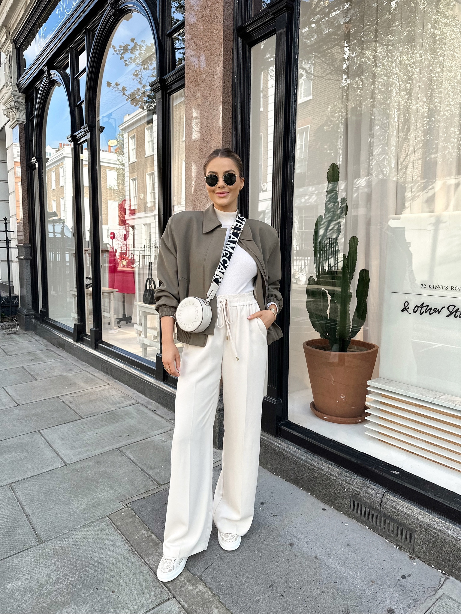 Cream and khaki spring outfit - Reiss cream tailored joggers, cream fine knit turtle neck jumper, khaki green zara cropped bomber jacket, rayban round sunnies, Stella McCartney round crossbody bag, Chloe Lauren cream lace trainers  

#LTKstyletip #LTKSeasonal #LTKeurope
