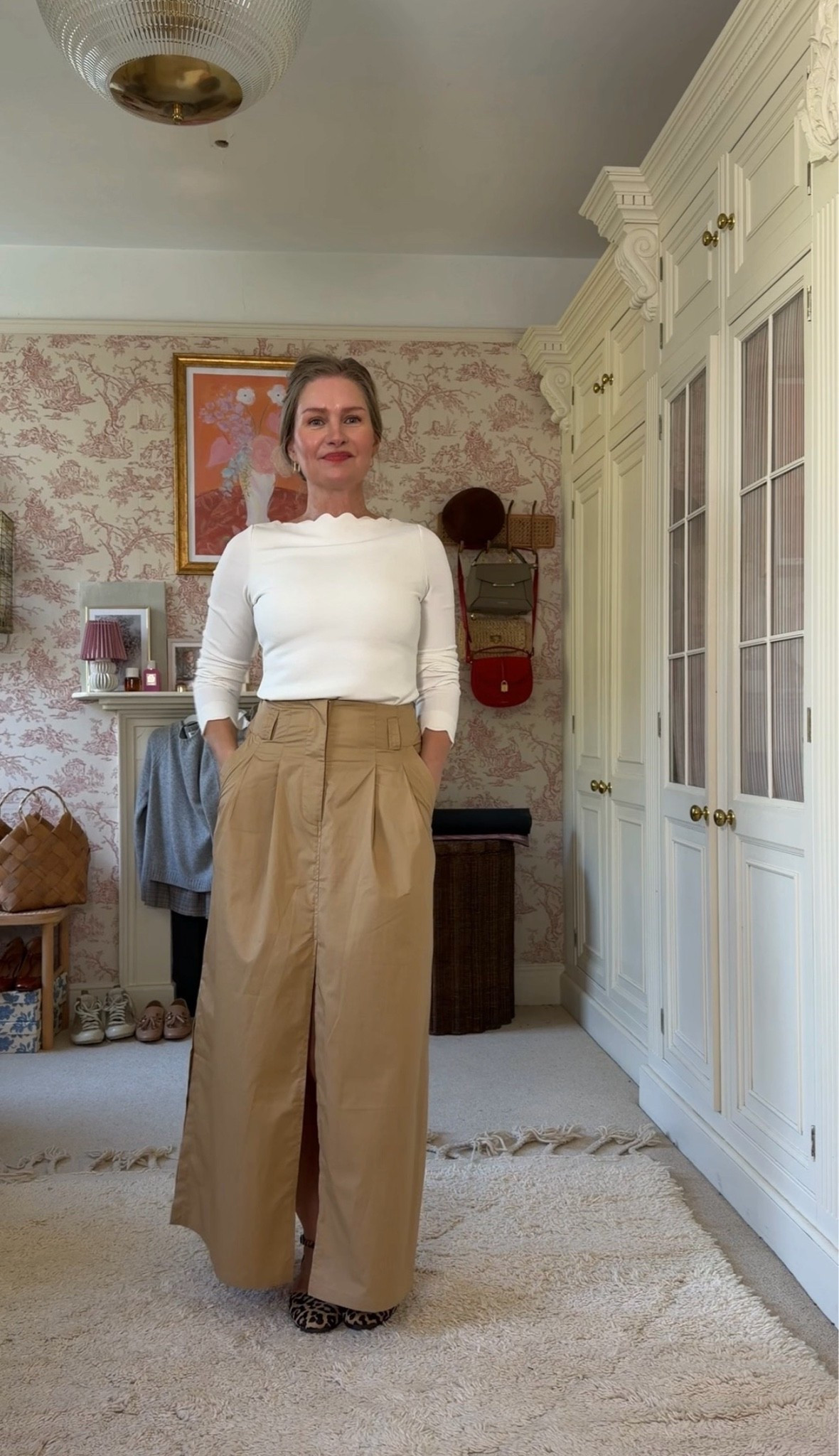 Autumn capsule wardrobe with four outfits - all the pieces can be mixed and matched. There’s a pleated linen maxi skirt, an oversized cotton maxi skirt, herringbone curved-leg trousers, a scallop neckline blouse, a spotted fluffy knit cardigan and a satin bow-tie blouse. Soft, relaxed Scandi style for women over 40, from the school run to Sunday lunch. I’m wearing a size M in everything except the trousers, which are an L.