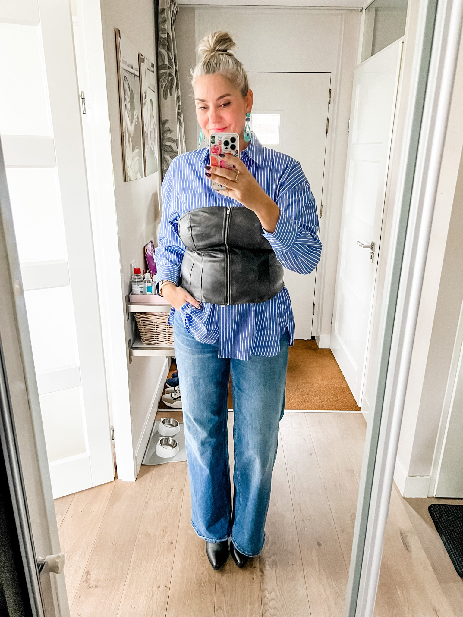 Ootd - Sunday. Blue striped button down shirt (old), faux leather bustier, wide leggings blue jeans (Shoeby), turquoise earrings, black pointy toe boots. 

#LTKnederlands #LTKautumn #LTKeurope