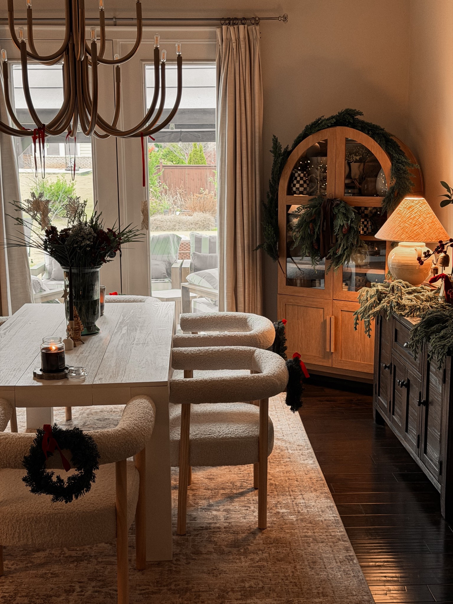 Holiday dinning room 

Arched cabinet, Wooden white dinning table, Boucle dinning chairs, Holiday garland, Holiday wreath, chandelier, brass, wooden sideboard 

#LTKSeasonal #LTKHome #LTKHoliday