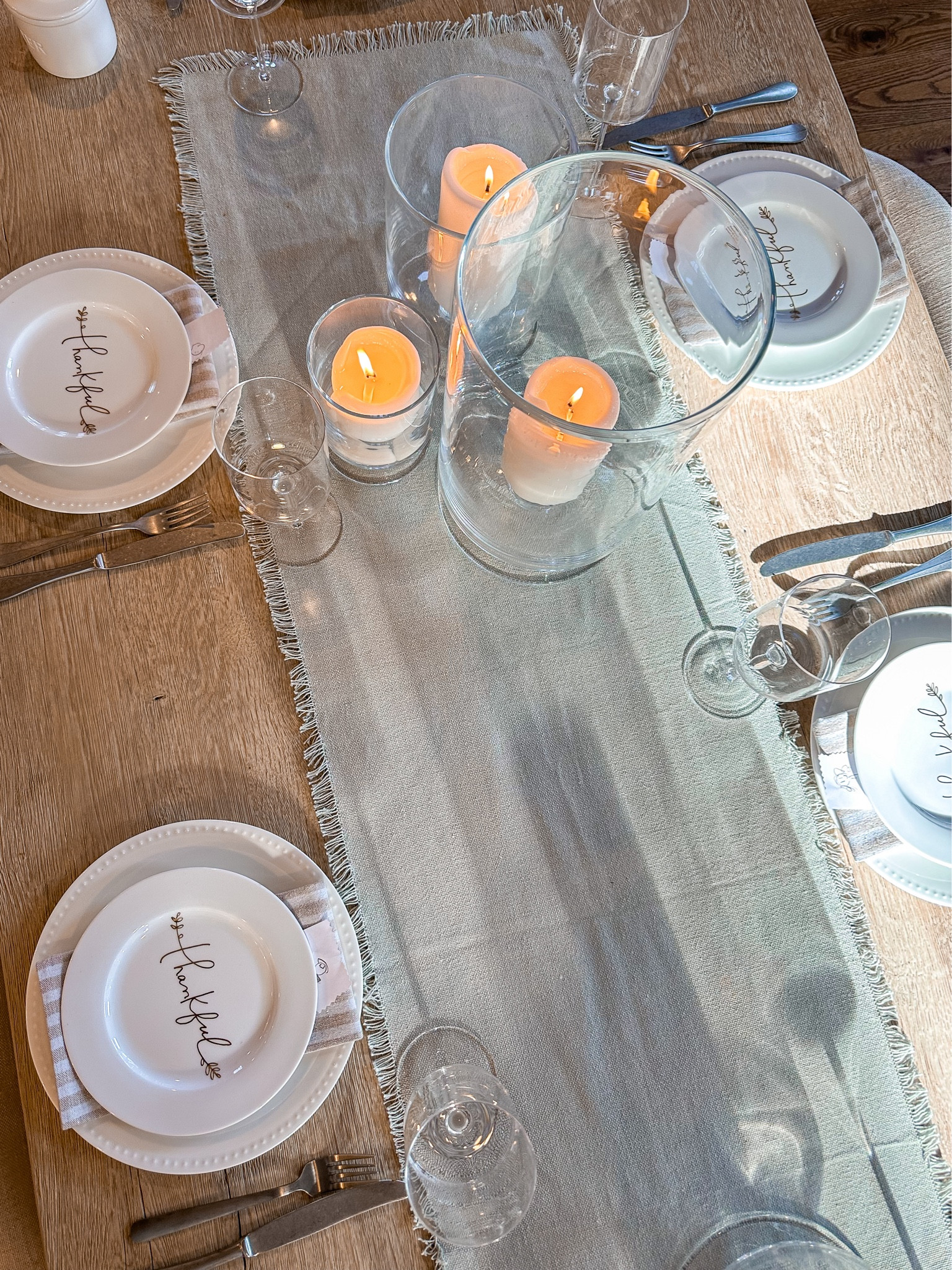Table setting for Thanksgiving. Neutral coastal decor is perfect for the holidays ahead with simple centerpiece of hurricanes and pillar candles  

#LTKSeasonal #LTKhome #LTKparties