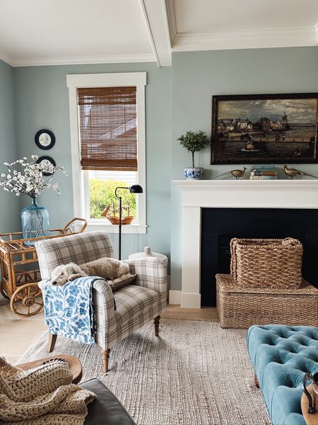 Living room decor - bamboo shades, plaid chair, tufted ottoman, boxwood topiary, jute and cotton rug 

#LTKSaleAlert #LTKSeasonal #LTKHome