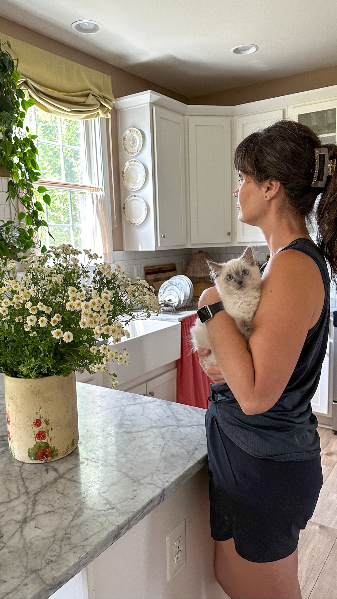 Ever notice how the quietest moments end up meaning the most? Lately, I’ve been slowing down in the kitchen and letting those little moments linger a little longer. My cats curl up nearby while fresh flowers brighten the countertops. The cafe curtains add charm while the light Kiwi green Roman shade brightens the space, turning ordinary afternoons into something that feels quietly magical. The soft hum of home, gentle purrs, and the scent of blooms are sweet reminders that joy is often hiding in the simplest corners of our days. 🌸
Love y’all mucho! 
.
Comment LIFE for all the details on this space and the beautiful shades/cafe curtains from @neutralcurtains 
.
.
.
.
#SlowLiving #neutralcurtains #CatLovers #HomeAesthetic #CozyHome

#LTKdayinmylife #LTKmomlife #LTKmorningroutine