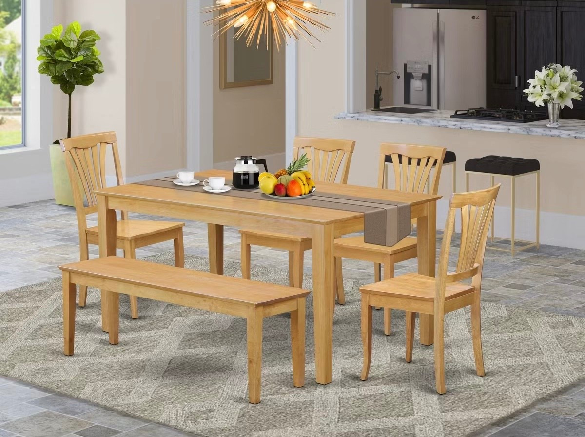 Light oak dining table set goals 🤍 This rectangular oak dining table with bench and chairs brings a clean, modern farmhouse feel to the space. Paired with a neutral geometric area rug, starburst gold chandelier, and simple tabletop decor, it’s the perfect setup for everyday meals or hosting.