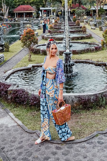 Vacation outfit. Vacation look. Tropical style. Print top and pants. Wide leg pants. Caramel bag. White shoes. Bali  inspiration. pattern two piece set. top and pants set. summer look. summer style. wicker bag. beach bag. crop top. #twopieceset #vacation #vacationlook #tropicalstyle #vacation #printset #travelinspiration #travellook #croptop #summerlook #wickerbag #fashioninspiration #stylingideas

#LTKstyletip #LTKfit #LTKtravel