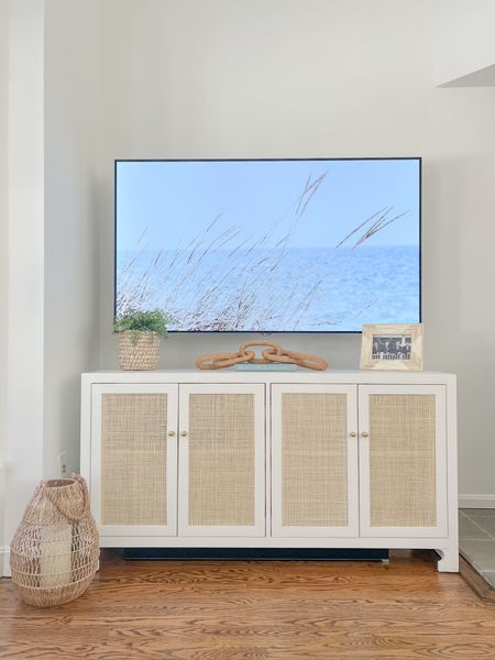 Sharing how I have my sideboard currently styled in my living room, which we use as a media console!
-
Living room decor, living room furniture, coastal living room, coastal home, coastal style, white sideboard, woven sideboard, console table, tv stand, faux plant, river grass planter, neutral sideboard, coastal interiors, beach house style, beach home, beach style, faux fern, hand woven bamboo lantern, rattan chain link, woven chain links, amazon coffee table books, coastal coffee table books, picture frames, photo frames, faux plants, planters, amazon decor, amazon home accessories 

#LTKhome #LTKfindsunder50 #LTKfindsunder100