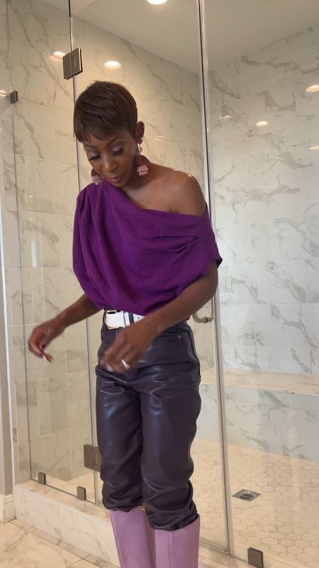 Monochromatic purple with faux leather pants, off the shoulder top, and purple boots 