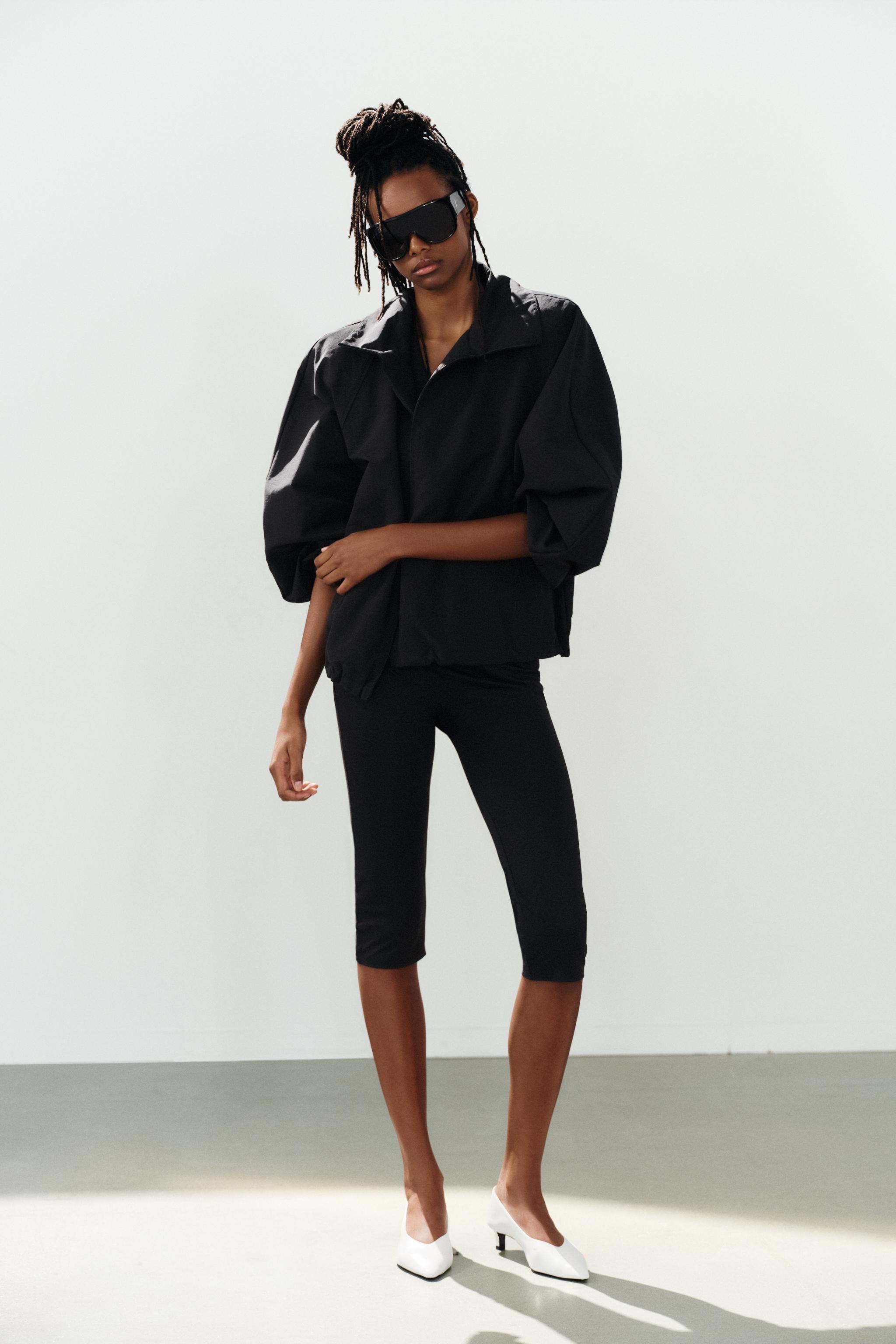 Jumpsuit made of stretch fabric. Features a halter neck and V-neckline. Above-the-knee length. | Zara US