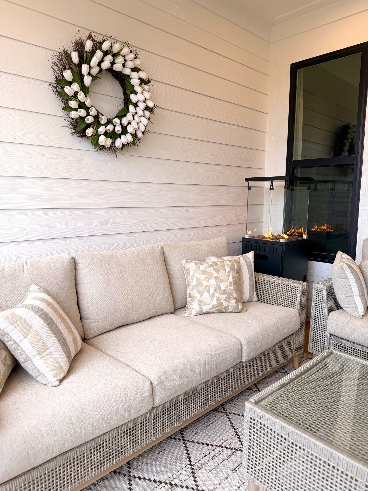 Creating a cozy little porch moment 🤍

Neutral textures, soft cushions, and a touch of warmth from the fire make this one of my favorite spots to unwind. I layered natural tones with woven details and a simple patterned rug to keep the space feeling light, calm, and inviting

#LTKOver40 #LTKSeasonal #LTKHome
