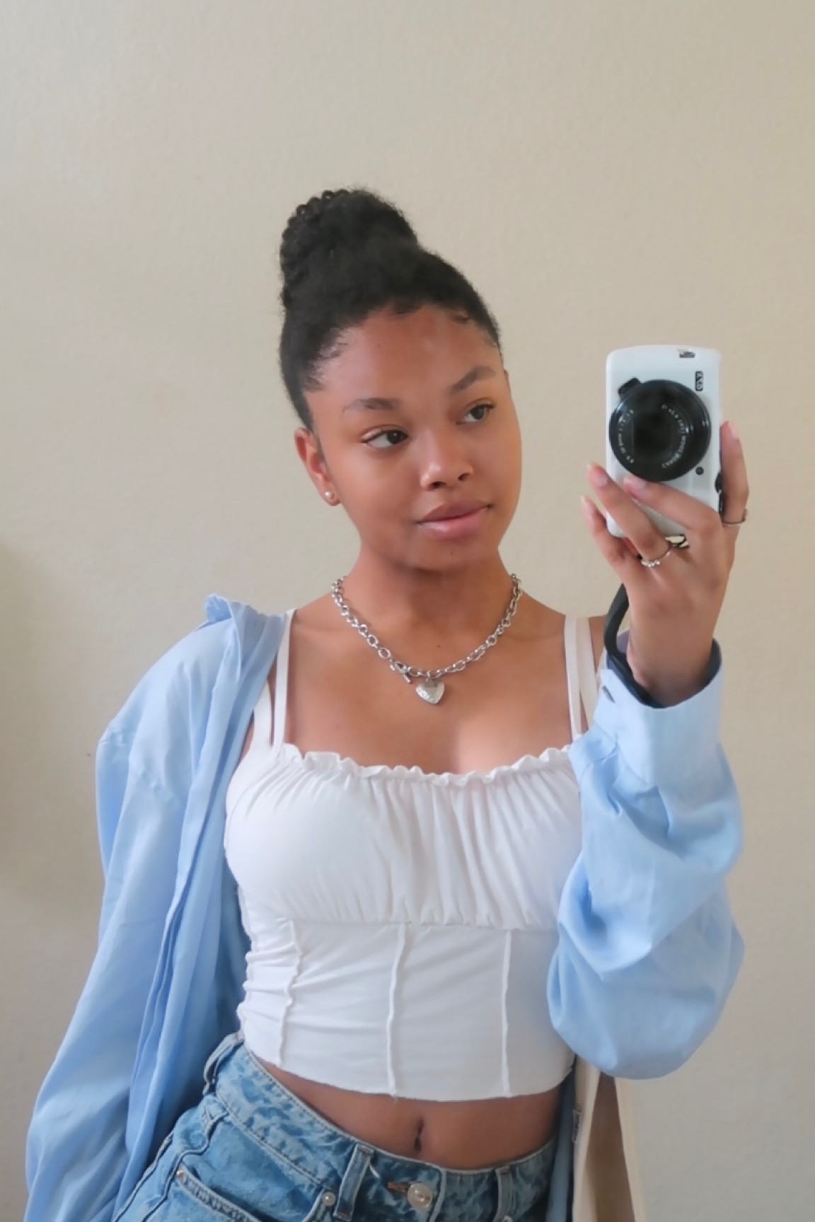 ruffle trim strappy camisole, white crop top, light blue button up shirt, light blue cardigan, silver chained heart necklace, silver jewelry, mid wash denim jeans, canon g7x mark ii, white camera case, vlog camera, beige tote bag

#LTKstyletip #LTKfit