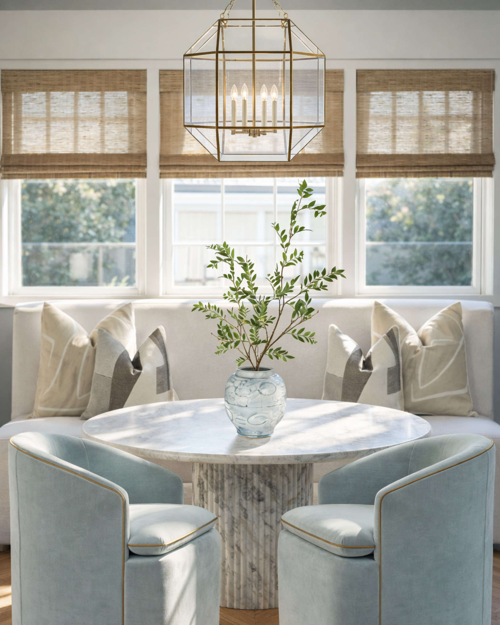 This is how you make a breakfast nook feel expensive without trying too hard.

The mix here is everything—soft blue velvet, warm brass, and that sculptural marble base all layered against natural light and woven textures. It feels elevated but still relaxed… like a space you actually want to sit in every morning.

If your dining area feels flat, start with contrast:
– curved chairs vs. straight lines
– soft upholstery vs. stone
– warm metals vs. cool tones

It’s the balance that makes it feel designed. 

 #LTKHome