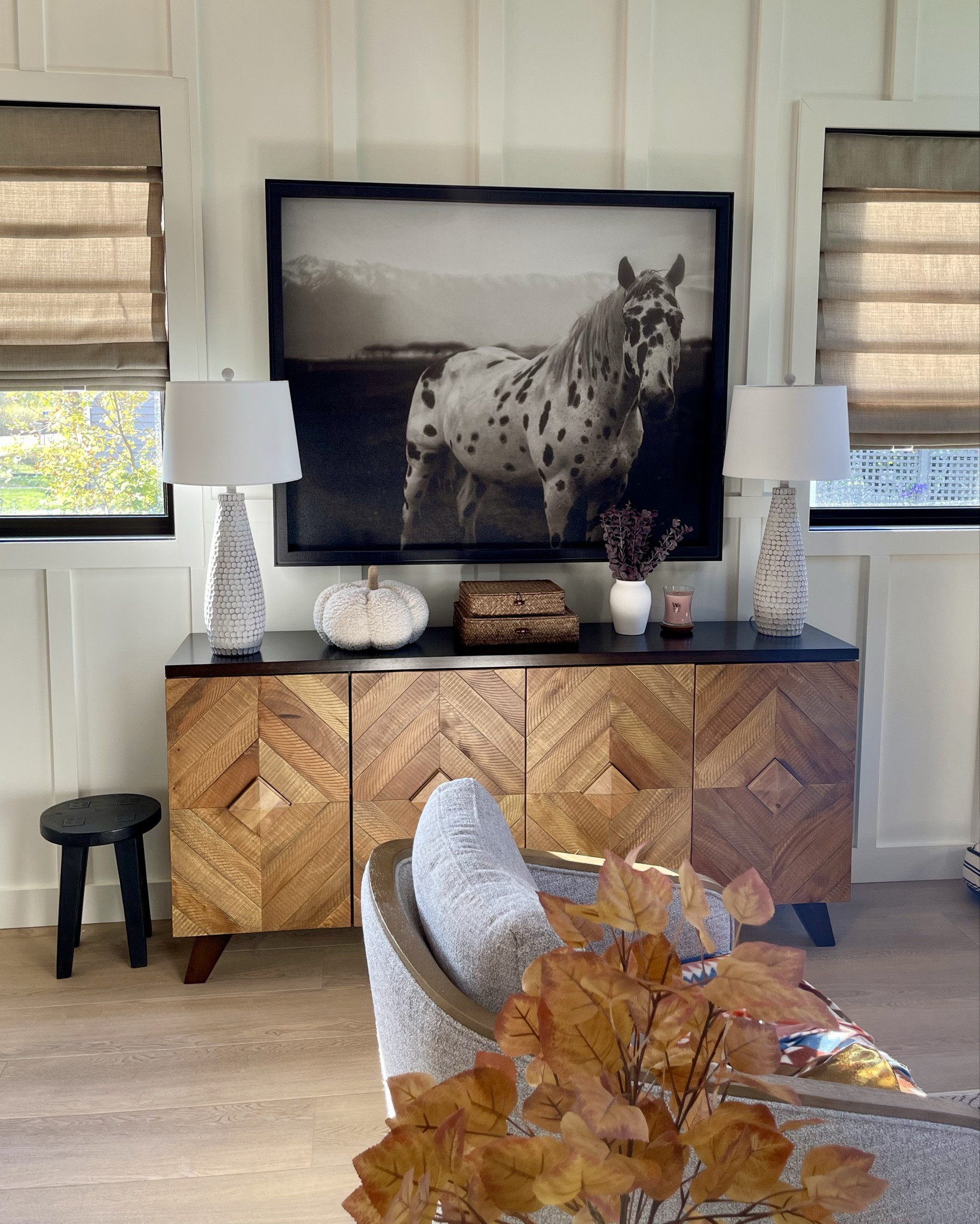 Warm wood tones & large art pieces are what’s trending now for Fall. This 4-door geometric large console table has lots of storage. I love my sepia toned large spotted horse wall art! Add tall textured table lamps to anchor the ends!
#falldecor


#LTKHome #LTKSeasonal #LTKStyleTip