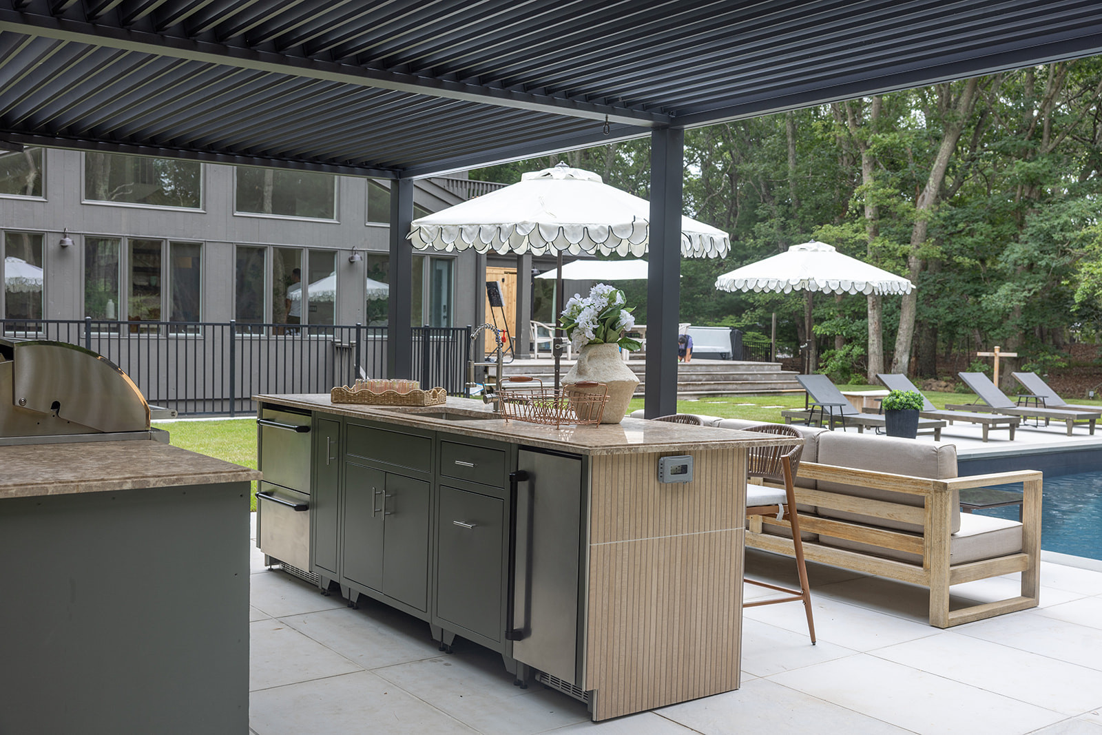 One of our biggest splurges at the Big House, but hopefully one that makes this the hangout house guests feel like they have to book. The outdoor kitchen has everything you need for a full day outside — fridge drawers, a sink, BBQ, barstools, TV, and an ice maker. And the best part? You don't even have to dry off to use it. Linking the exact and similar pieces here.

#LTKActive #LTKHome #LTKSaleAlert