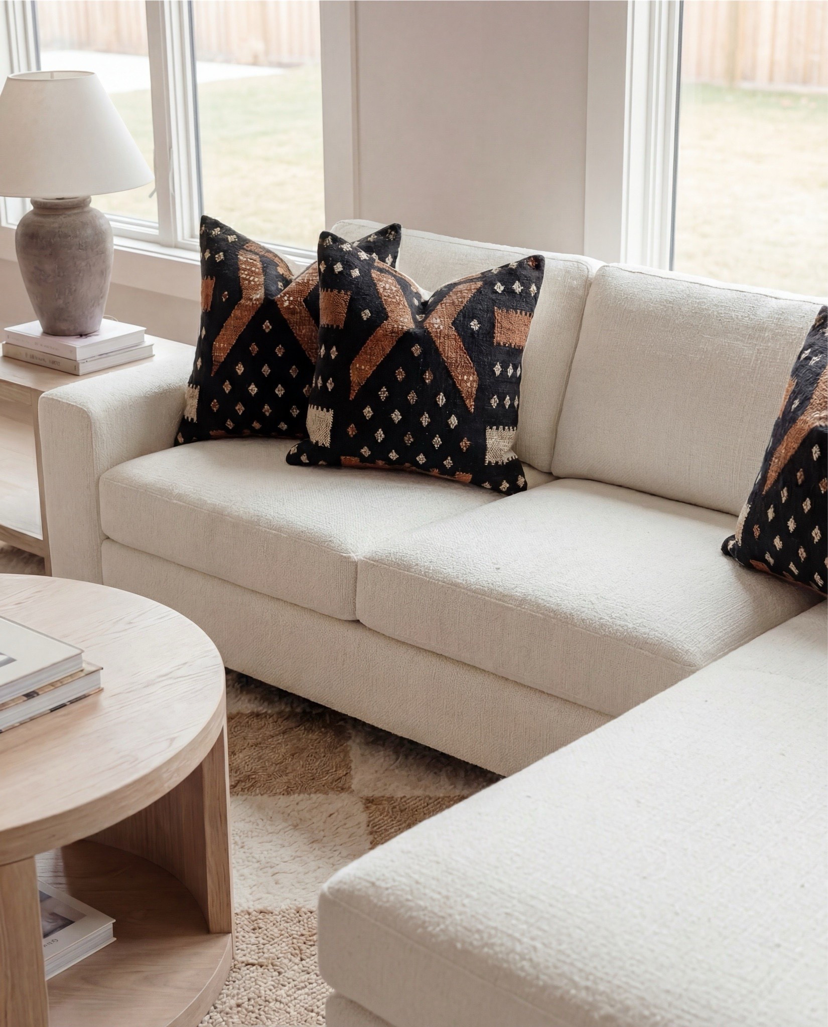 ✨ Shop the look:
Caramel boucle swivel chairs | Caramel curved sofa | Plush square boucle ottomans | Neutral diamond-pattern rug | Light natural wood nesting coffee tables | Stone-look ceramic vases | Light oak built-ins | Dramatic brown-veined marble fireplace | Exposed oak ceiling beams | Glass globe pendant . White boucle ottoman , white sectional sofa 

#LTKSaleAlert #LTKHome