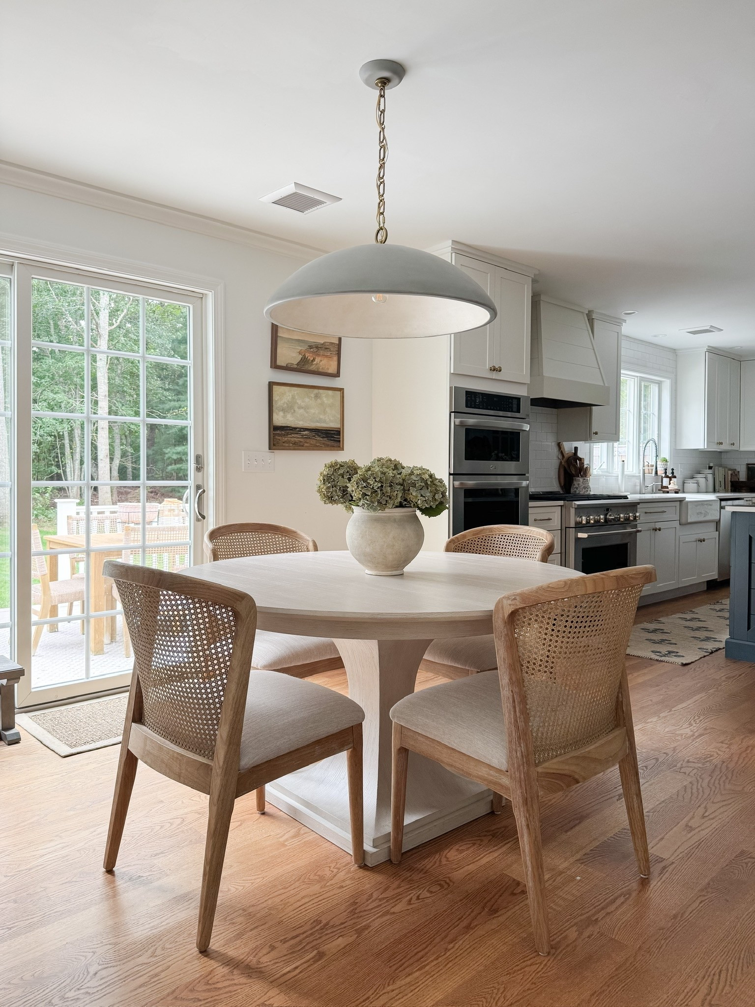 coastal dining room decor, round wood dining table, woven dining chairs, faux hydrangea centerpiece, neutral dining room styling, coastal interior decor, light coastal home, neutral dining room inspiration, sherricalnanhome

#LTKHome