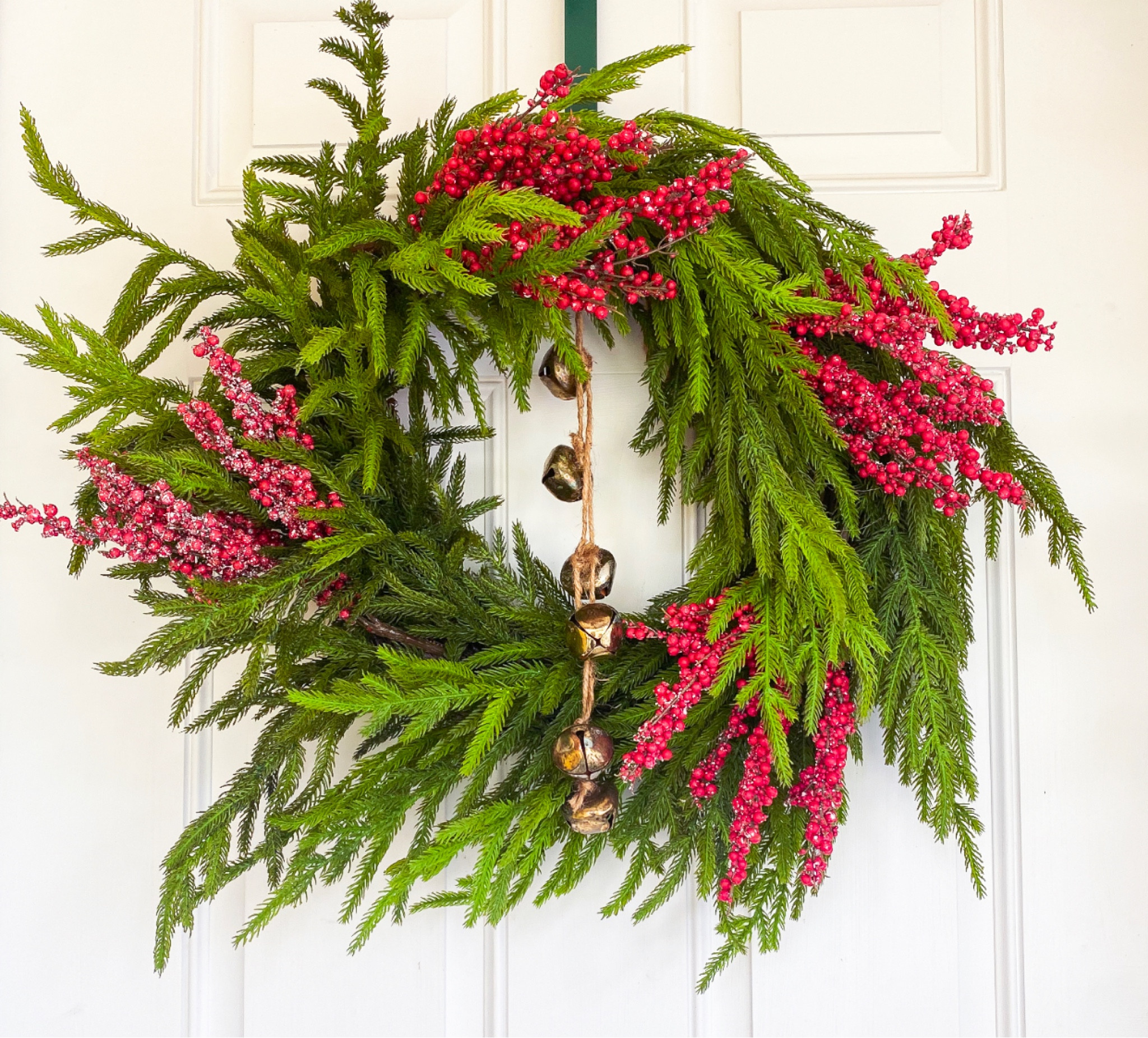 This beautiful wreath I scored on amazon and added a few simple frosted berry sprigs and Did a diy of my vintage bells. 

#LTKSeasonal #LTKHoliday #LTKhome