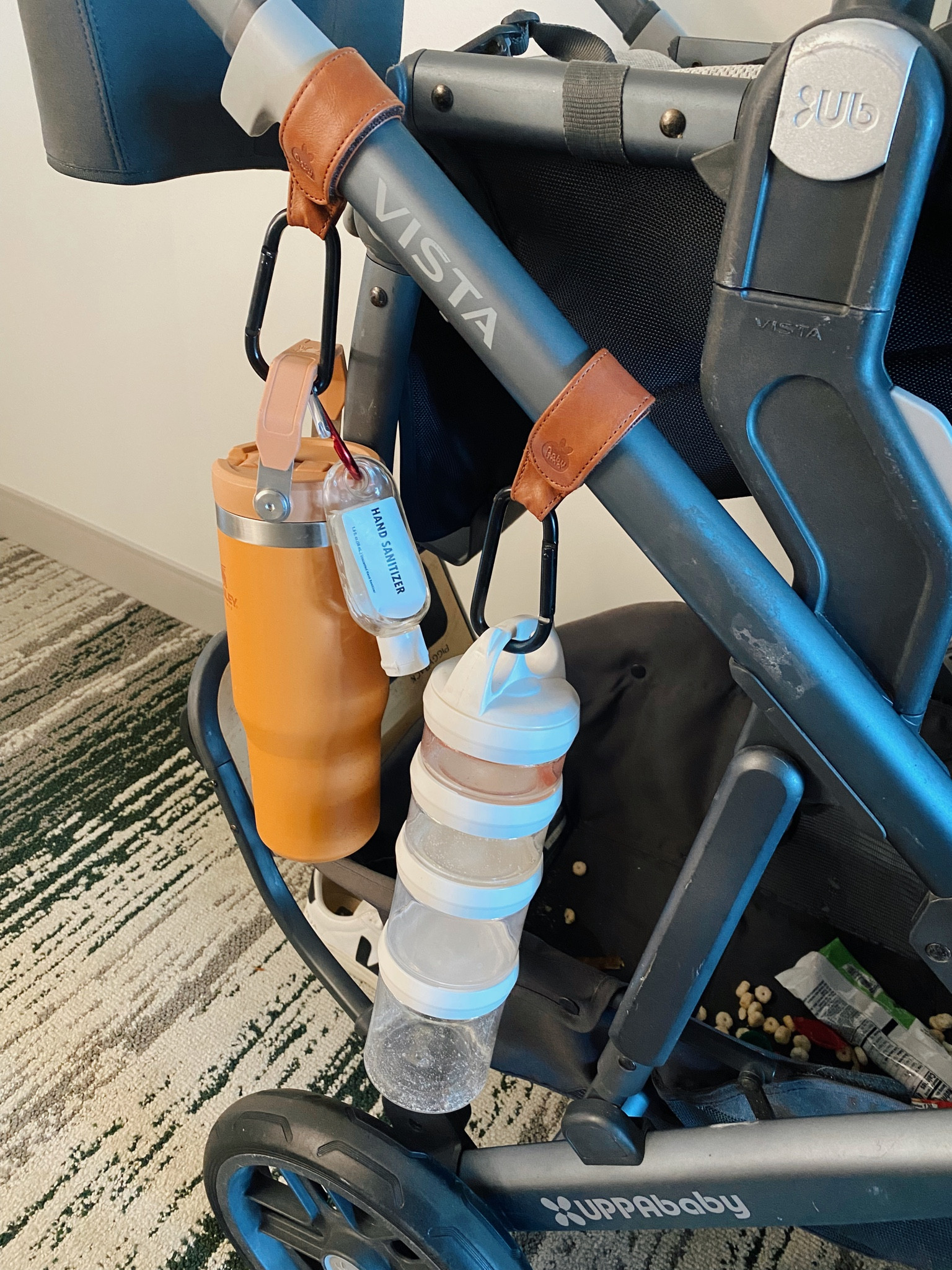 The dynamic set up for Disney world! Using carabiner hooks with Velcro to hold Stanley water bottles or kids yeti water bottles, hand sanitizer and a snack organizer! A game changer for the parks and even every day use! 

#LTKunder50 #LTKfamily #LTKtravel