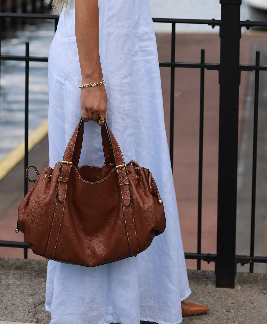 Summer ease. This breezy look features a light blue linen maxi dress paired with a rich cognac leather tote and matching pointed-toe flats. #LinenDress #SummerStyle #LTKbeach 

 #LTKSpringSale #LTKdayinmylife #LTKootd