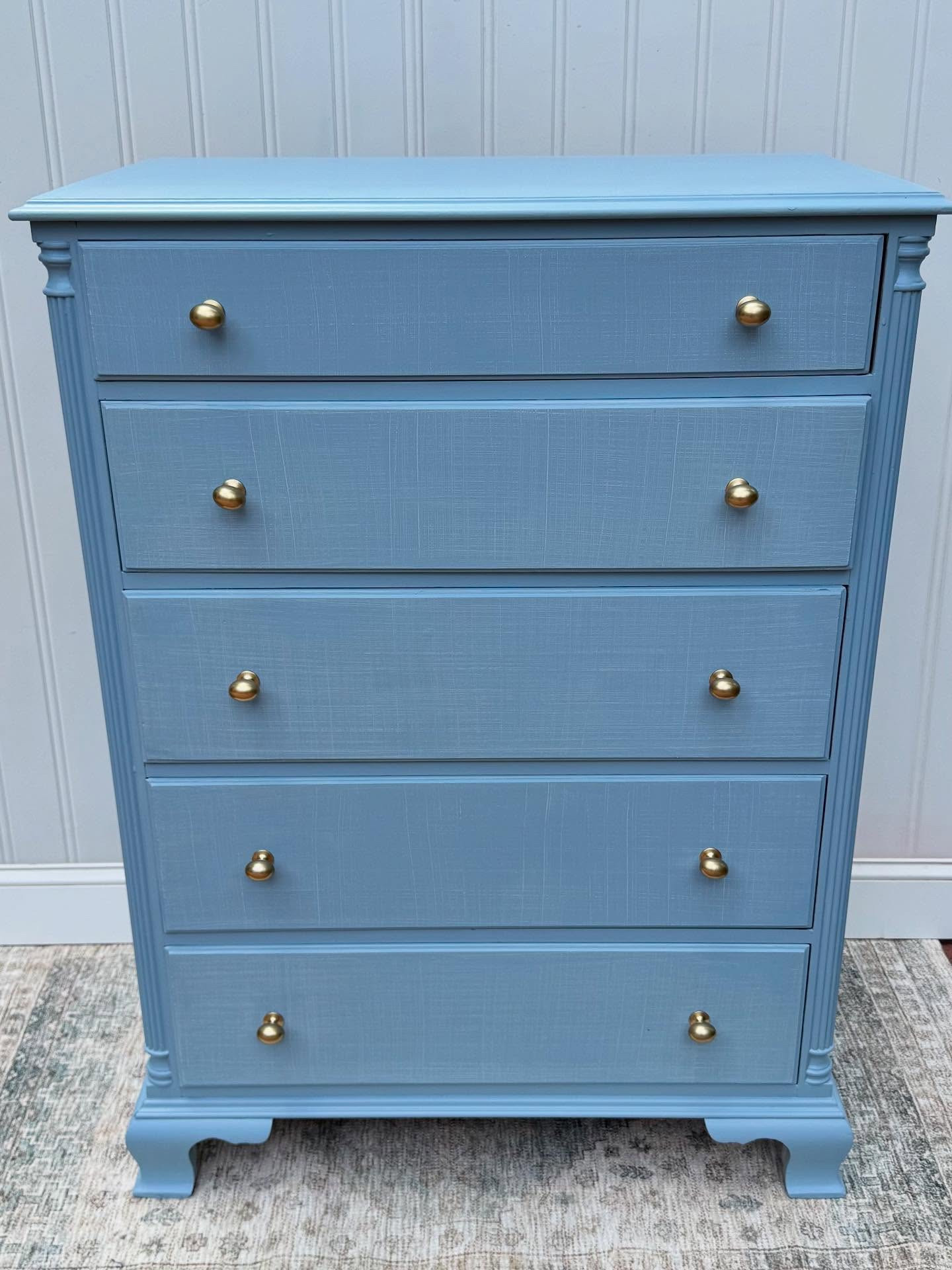 This is your sign to upgrade your dresser!! 

Painted in “Waterview” with a linen-textured finish and gold knobs.

⭐️SOLD 
48” tall x 35” wide x 21” deep, solid wood with dovetail drawers, slide in the DMs before someone else does⭐️

#FurnitureFlip #DresserMakeover #BlueDresser #RefinishedFurniture