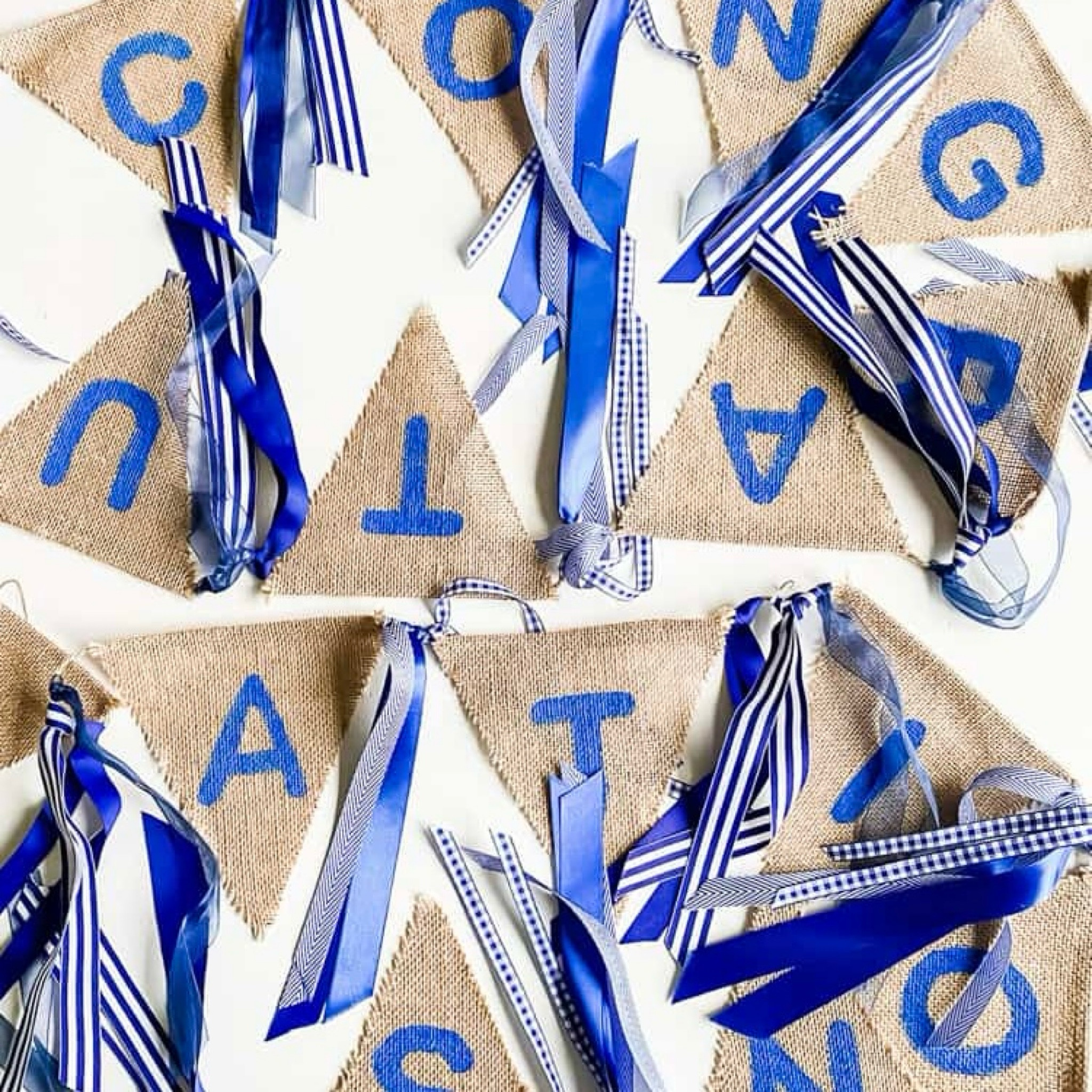 Need some easy and affordable graduation party decoration ideas? Make this DIY burlap banner! All you need is a burlap pennant banner, ribbon, paint, and scissors. 

#LTKparties #LTKstyletip #LTKfindsunder50