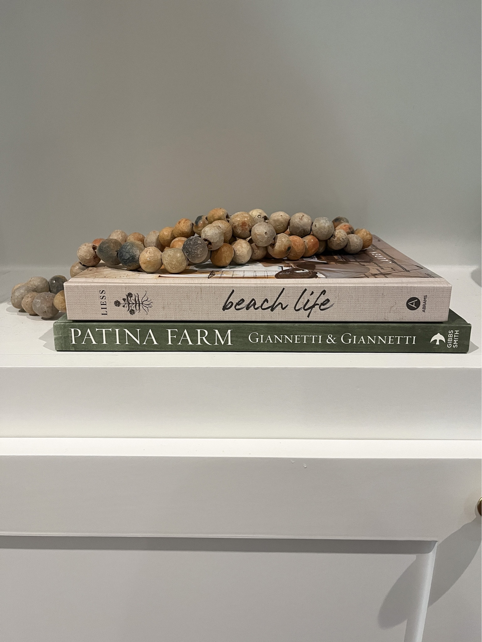 Coffee table books and bead garland 

#LTKsalealert #LTKhome #LTKstyletip