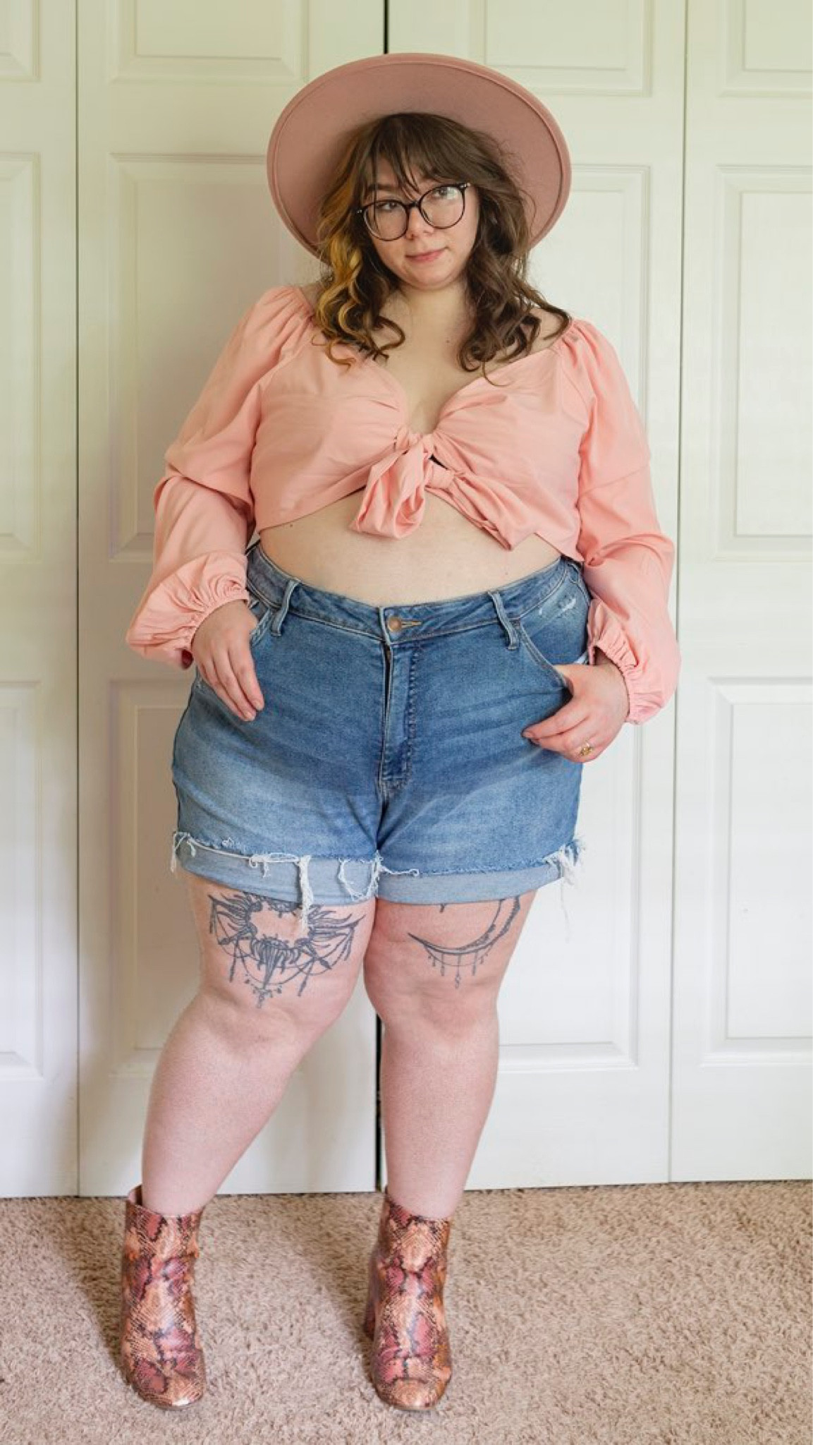 Plus size pink hat pink puffy sleeve pink bishop sleeve pink tie front blouse denim shorts snake boots outfit 

#LTKcurves #LTKSeasonal #LTKstyletip