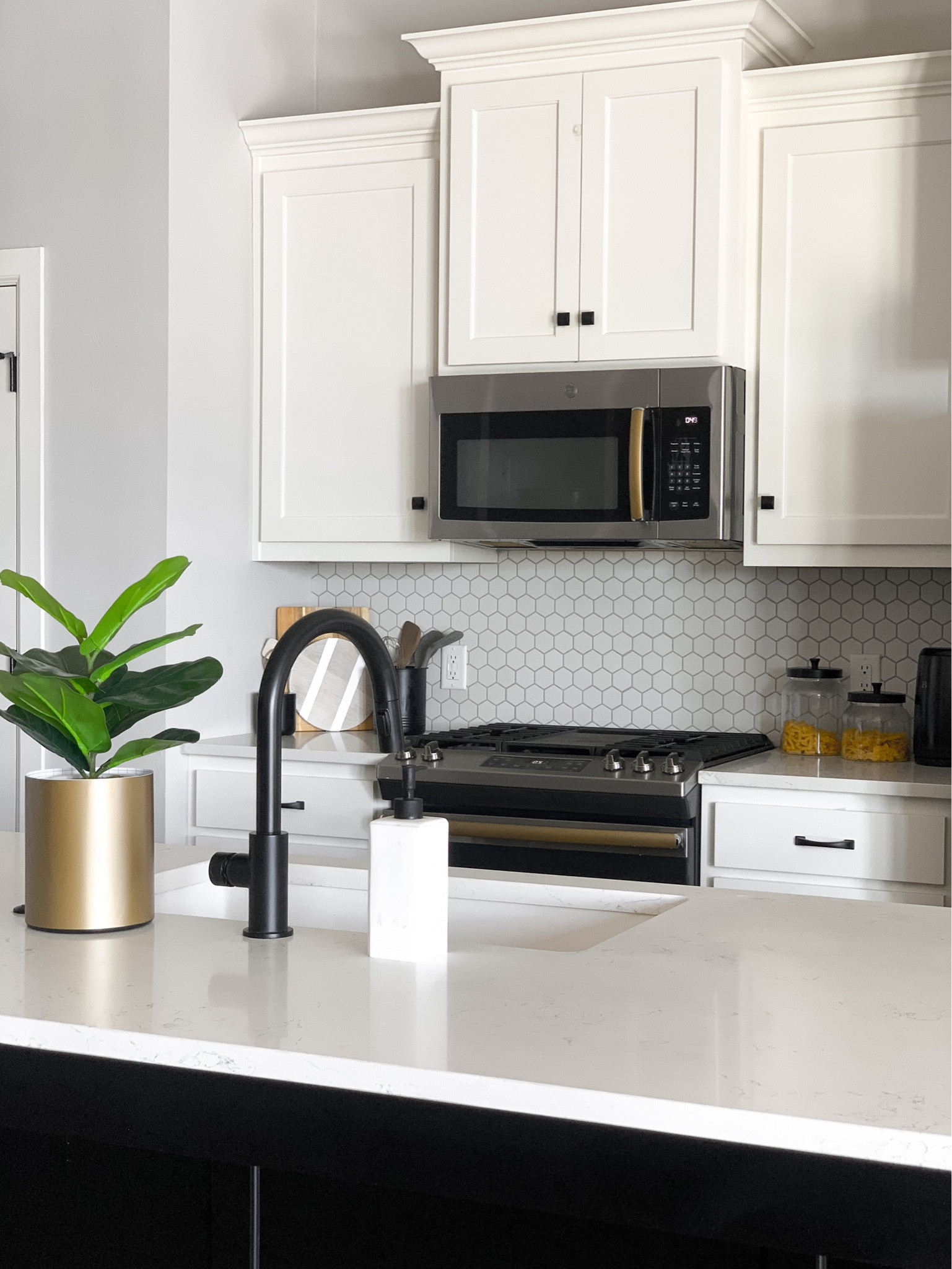 Simple and minimal kitchen styling 

Kitchen decor, kitchen countertop decor, faucet, soap dispenser, faux plant, planter, glass containers, wood boards, water kettlee

#LTKhome #LTKstyletip #LTKfindsunder50