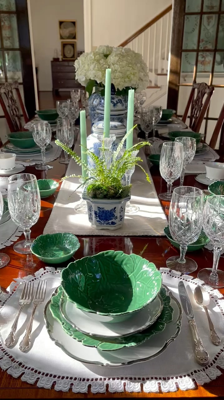 Happy Wednesday, sweet friends! 🌿 Whether you’re in the midst of planning a heartwarming baby shower, an enchanting bridal shower, or something special for friends or family, I’m throwing it back to a table setting that might just light your creative spark. 💙🌿✨

Dive into this table that whispers elegance and blooms with undeniable charm. 💙✨ Starting with a neutral runner, surrounded by dainty white placemats and napkins, crowned with dinnerware that gracefully transitions from pristine vintage white china to vibrant green cabbage ware. All of it  echoes the beauty of Summer. Add silverware, with crystal glasses glimmering in the sunlight, ready to be filled with stories and laughter 🍽️💫. At its heart, a row of chinoiserie ginger jars, the center jar filled with white hydrangeas stand proudly. In addition, the timeless blue and white patterns complemented by the verdant lushness of ferns in matching planters, and green candles in crystal holders. Here’s to those meals that blossom into cherished memories and table settings that make every heart feel at home 🏡🕯️💙🌿.

What do you think? 💙💭 I’m already dreaming up ways to give this table a fresh twist and can’t wait to share the magic with you all. Stay tuned! Hope this brings a little joy and inspiration to your afternoon. Have a beautiful one, friends! 💙🌿☀️
.
.
.
#entertainathome #southernladymagazine #mycollectedhome #grandmillenialhome #styleonmytable #betterhomeandgardens #postitandsmile #dressingthetable #traditionalhomedecor #timelesshome #southernladymag #grannychicdecor #playwithyourdishes #summertablescape #centerpieceideas #tablescapeideas #entertainandcelebrate #diningtabledecor #blueandwhitedecor 

#LTKStyleTip #LTKVideo #LTKHome