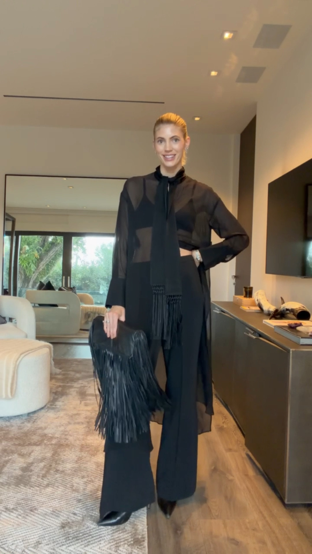 How fun is this top?!🖤 I love the tassel details on the top paired with this great black trousers. This fringe bag is such a great statement piece while still staying neutral because it’s black! 

#LTKSeasonal #LTKootd #LTKgrwm