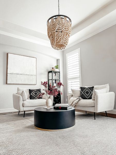 Front living room. Boucle accent chairs. Black modern coffee table. Beaded chandelier  

#LTKstyletip #LTKfindsunder50 #LTKhome