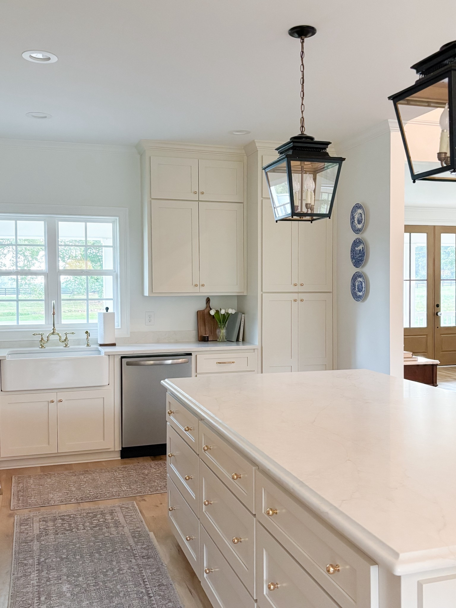 Neutral kitchen, beige cabinets, lantern pendants, kitchen island, kitchen pendants, farmhouse sink, bridge faucet, unlaquered brass, polished brass, cabinet hardwaree

#LTKHome