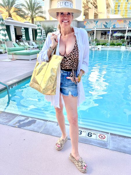 Travel 
Pool side look🌴☀️

Summersalt swimsuit leopard& black  waist tie one piece 
Fits tts unless you have larger breast size up. 

Risen denim shorts fits tts size 27, affordable, comfortable and easy to wear

Gold metallic large tote, perfect for travel and pool/ beach  days by quilted koala save 20% with code DARCY20 

White button up frayed hem shirt 
(Old linked similar) 

Gucci platform slide sandals 

Hat Gigi pip

Gucci hat band (no longer available) 

Buddha girl - gold water proof  bracelets
Lightweight, chic and great for layering 


#LTKswim #LTKshoecrush #LTKtravel