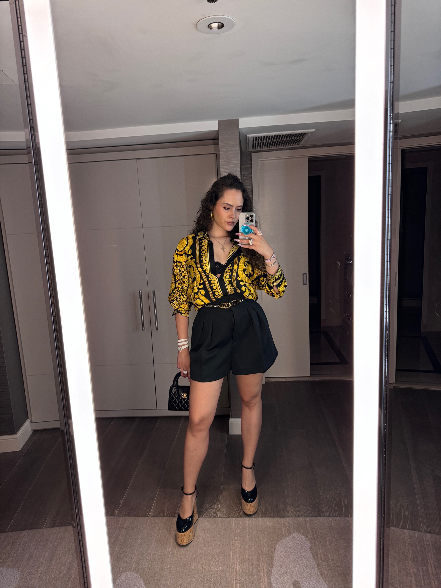 Printed silk shirt, shorts, gold chain belt, heel wedges, black top handle quilted bag

#LTKeurope #LTKSeasonal #LTKstyletip