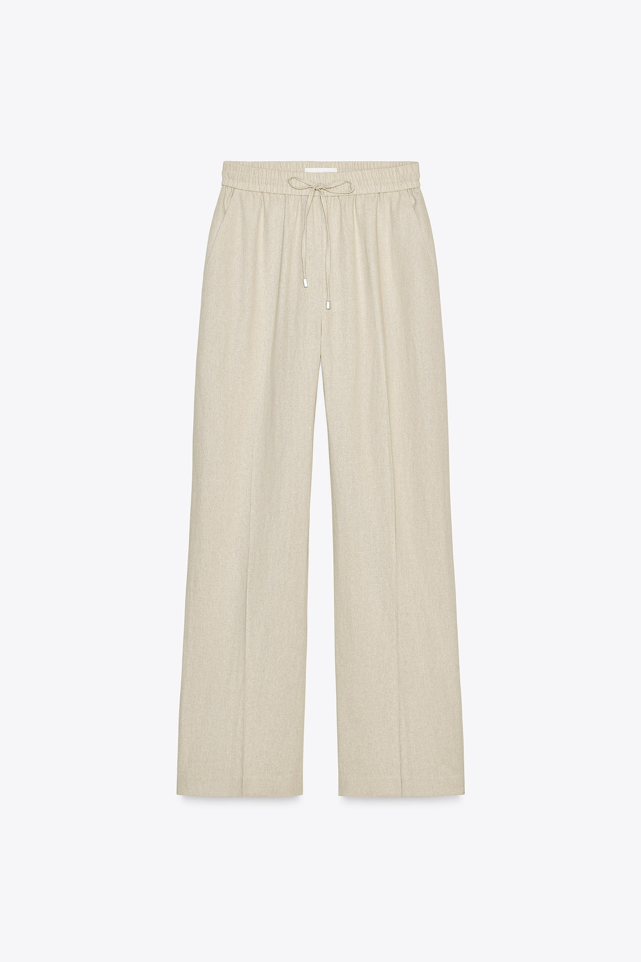 High-waist trousers made of a linen blend. Adjustable elasticated waistband with drawstrings. Fro... | Zara UK