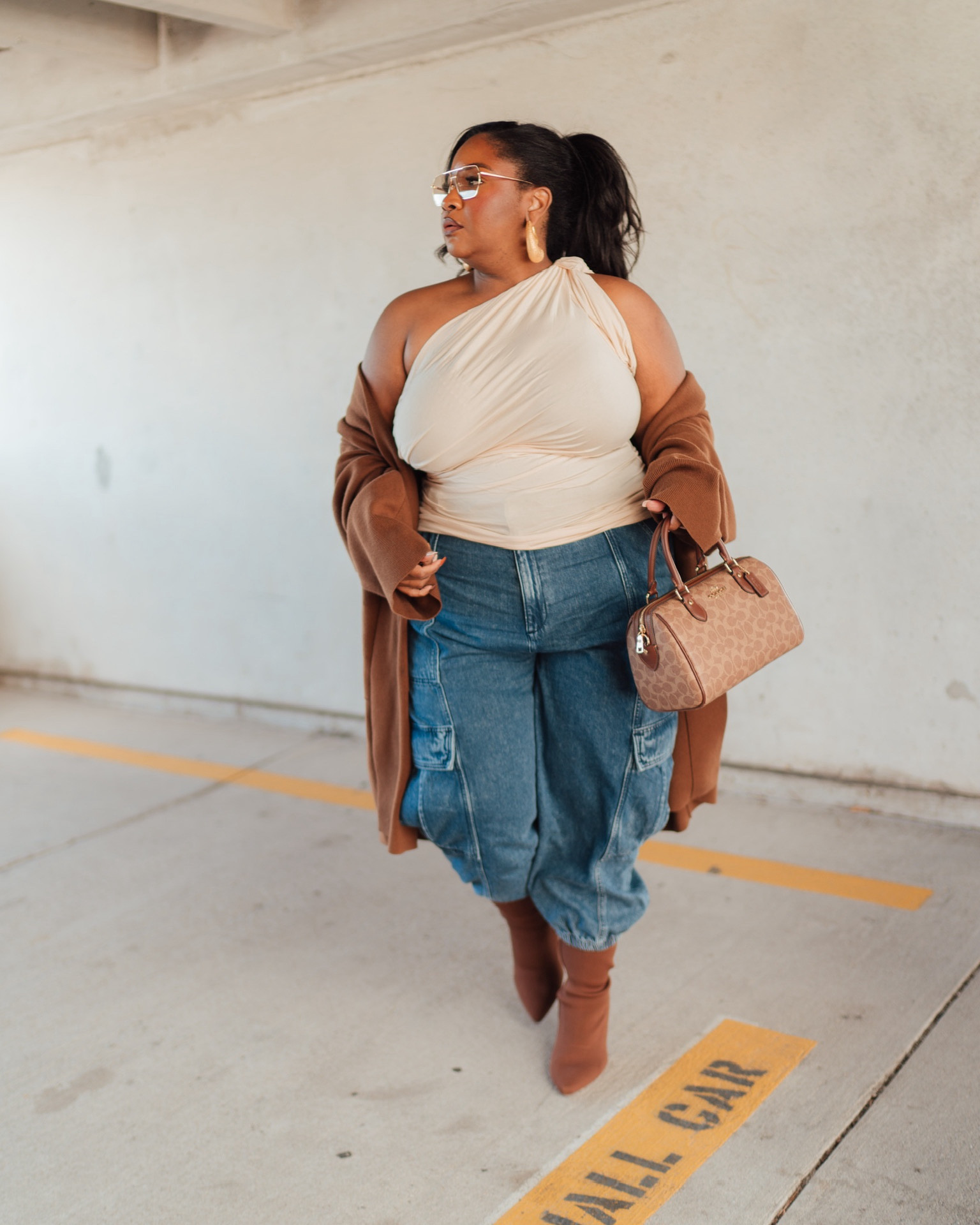 ✨ Elevated casual plus size outfit idea. 

Top from Eloquii, jeans from Walmart, styled with a Coach bag, 12PM Studios shades, and ShopKOI earrings.