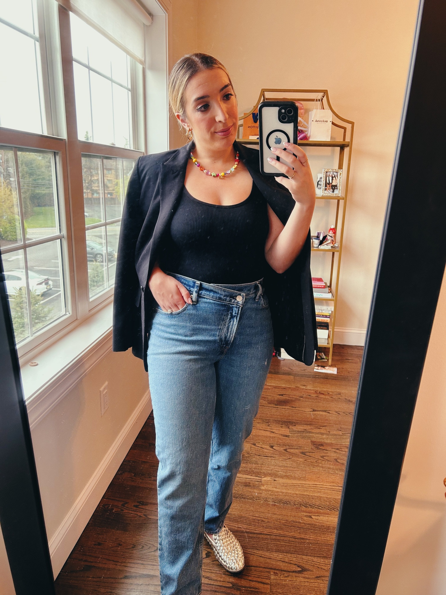 My go to busy work day fit! A black tank bodysuit, oversized black blazer, fun jewelry, high waisted asymmetrical straight leg jeans, statement shoe to break up the solids (ballet studded loafers).

#LTKsalealert #LTKworkwear #LTKstyletip