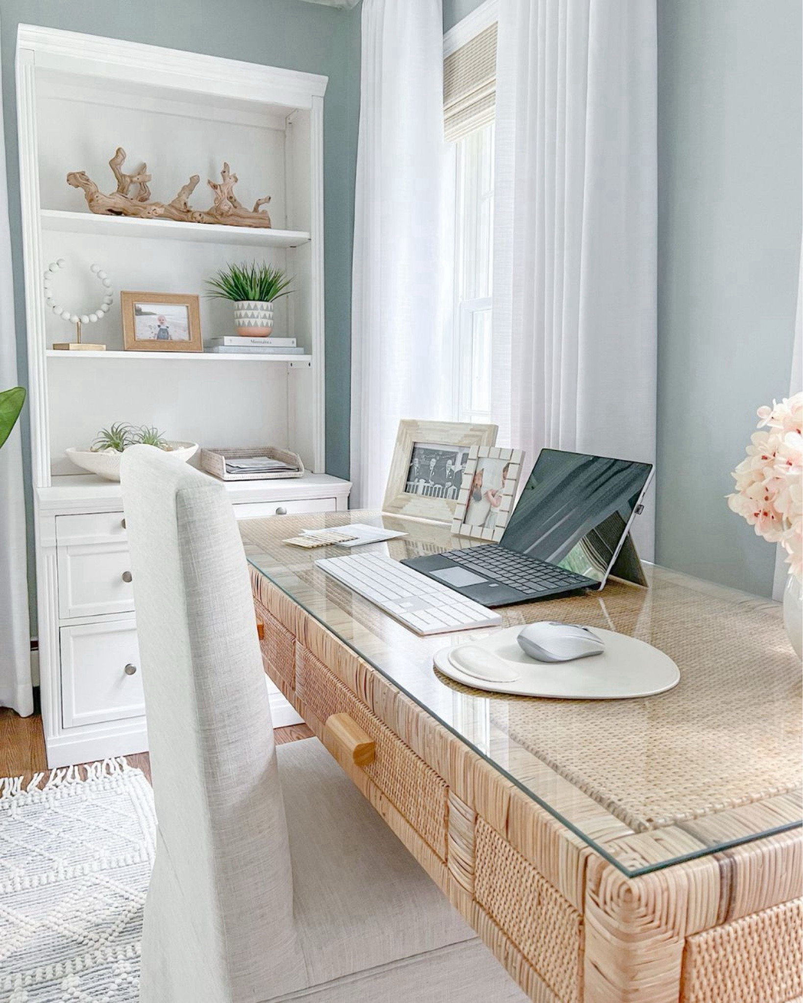 Home office views! I love working in here in the mornings when the sun in streaming through the windows. Desk no longer available but linking a very similar one from Amazon!
-
Home office, office furniture, office rug, coastal home decor, neutral home decor, neutral furniture, coastal desk, rattan desk, woven desk, large rug, faux plant, home office desk, natural desk, beach home style, beach style, coastal style, amazon home decor, bookshelf styling ideas, bookshelf decor, white bookcases, white shelves, white file cabinet, white home office furniture, pottery barn shelves, woven shades, woven blinds, window treatments, driftwood branch, coastal coffee table books, amazon coffee table books, decorative objects, shelf accessories, planters, decorative bowls, bowl filler, picture frames, amazon desks, white curtains, white drapes, amazon curtains, amazon drapes, white vases, amazon vases, office organization, black curtain rod, amazon chandelier, white beaded chandelier, blue & white rugs, coastal rugs, rugs with fringe, textured rugs, 8x10 rugs, 5x8 rugs, 6x9 rugs, desk chairs 

#LTKFindsUnder100 #LTKFindsUnder50 #LTKHome