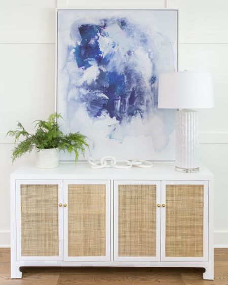 Design inspiration for your office. Items include abstract wall art, a white console table with rattan doors, a faux fern, a marble chain, and a glass table lamp.  Additional items not shown include swivel upholstered chairs, raffia bookshelves, wooden x-leg desks and a wood bead chandelier. 

#ltkseasonal simple decor, home office inspiration, home office design, office inspo, abstract wall art, wall décor, office décor, office chairs, office desks, pottery barn home office, amazon lamps, amazon finds, amazon home décor, neutral decor, coastal decorating, coastal design, coastal inspiration   #ltkfamily #ltkfind 

#LTKSeasonal #LTKstyletip #LTKunder50 #LTKhome #LTKsalealert #LTKunder100 #LTKunder100 #LTKstyletip #LTKhome