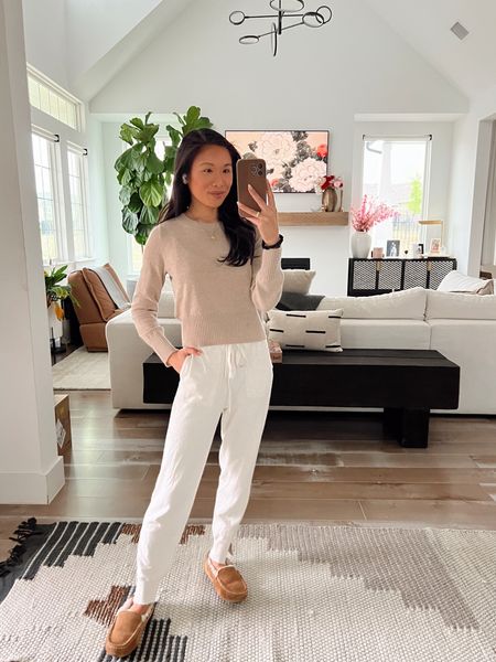 Casual cozy athleisure outfit with a light tan cashmere cropped sweater, cream sweater joggers and comfy slippers. Lip liner is caffeine anywhere and lipstick is peach nude  

#LTKstyletip