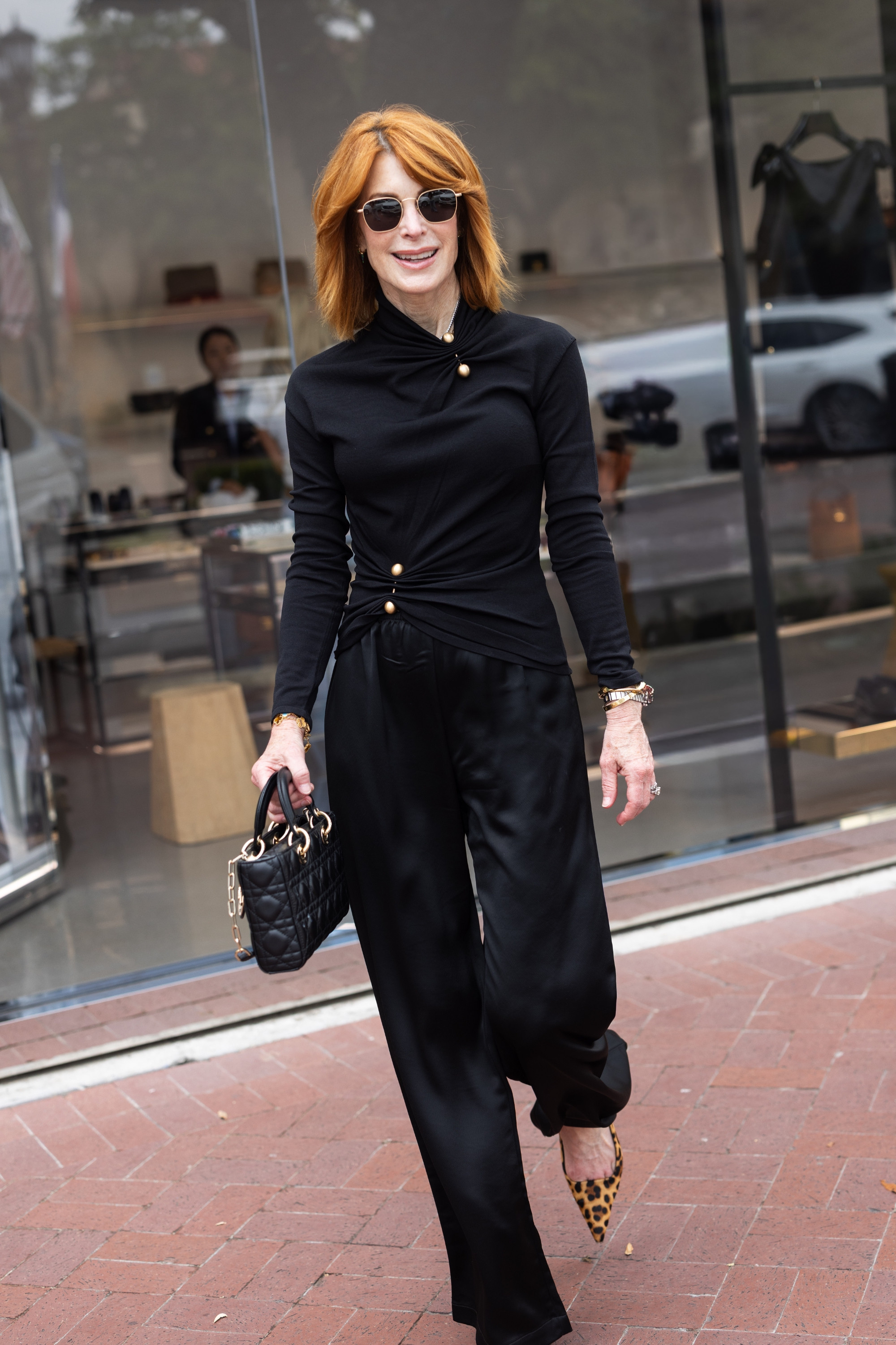 This black statement top is anything but basic. The draped fit and gold button detail make it feel polished and modern, especially styled with relaxed black pants and leopard heels for date night outfits or fall work outfits. #LTKOver40 #DateNightOutfits #FallOutfits #WorkOutfits #FashionOver40 

 #LTKootd #LTKSeasonal #LTKOver40