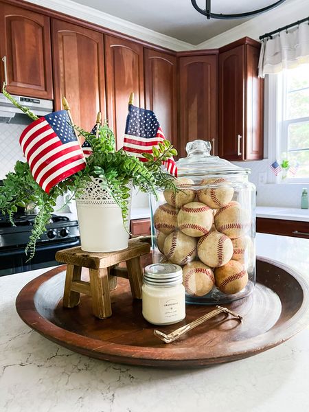 Decorate for summer! Centerpiece idea. Kitchen island. Vintage baseballs. Mini stool riser. Large glass container with lid. Mini American flags. Faux ferns. Gold candle wick trimmer.

#LTKSeasonal #LTKstyletip #LTKhome
