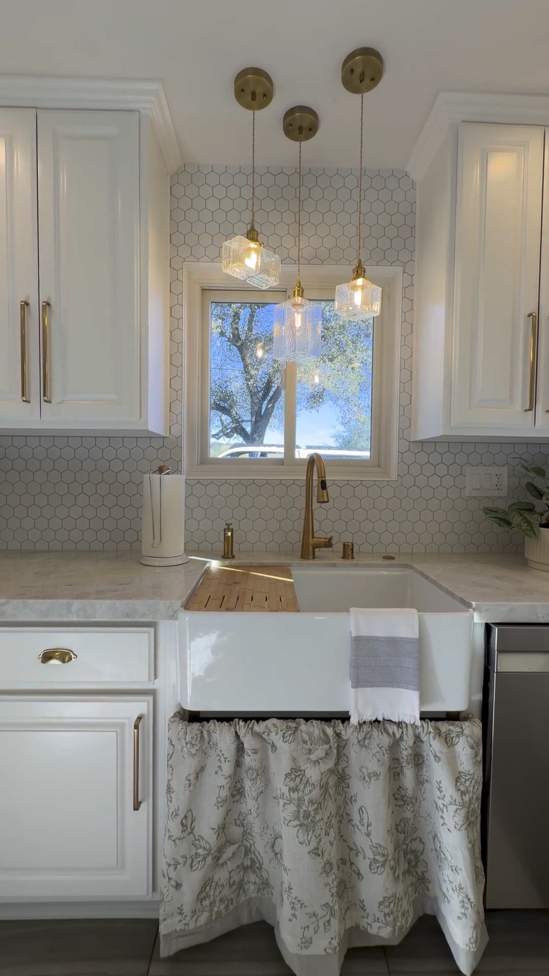 We spend so much time at the sink—why not make it beautiful? Gold hardware, statement lighting, and simple styling go a long way in making the kitchen feel just right. 

 #LTKHome